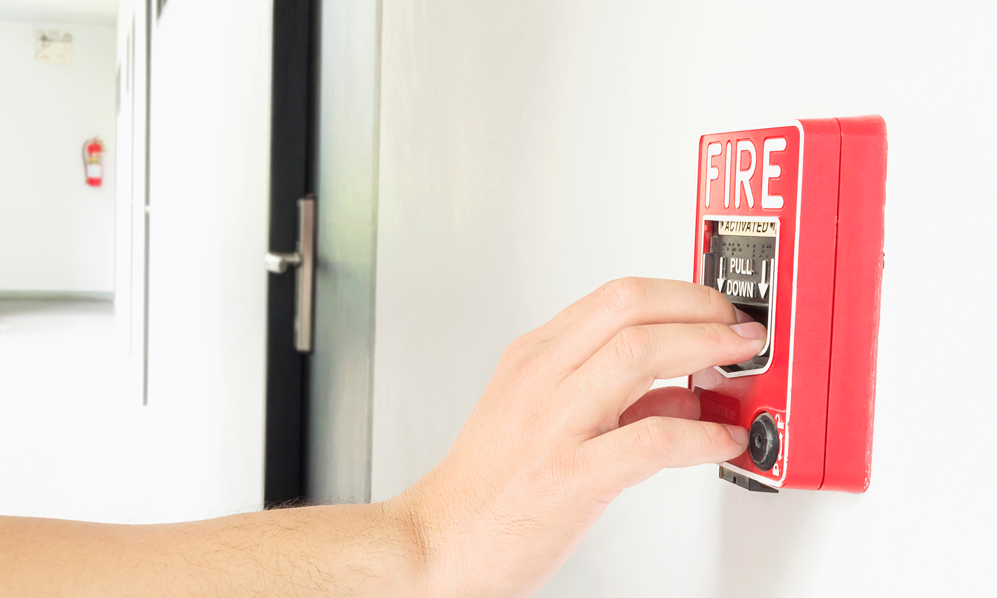 man-is-reaching-his-hand-push-fire-alarm-hand-station 1